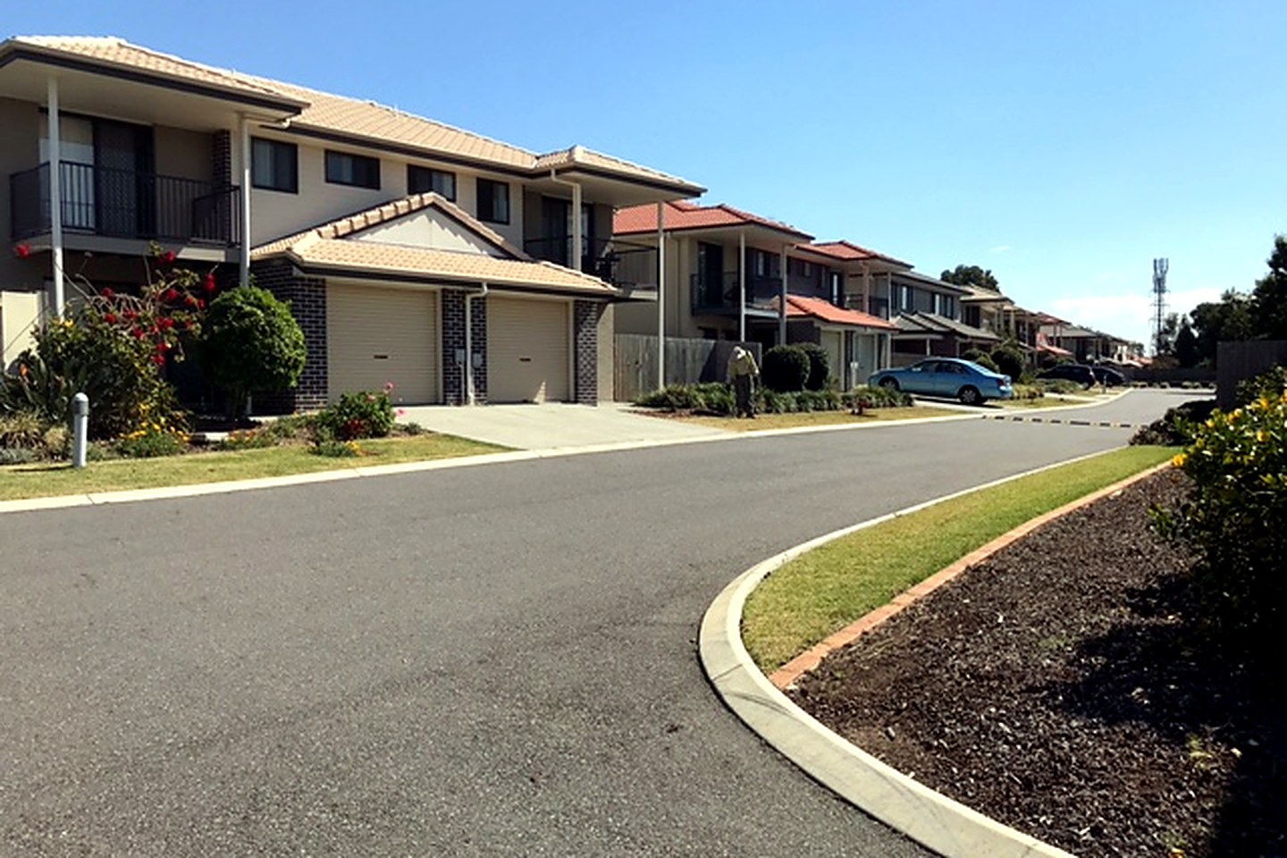Townhouse streetscape with private garages and established gardens