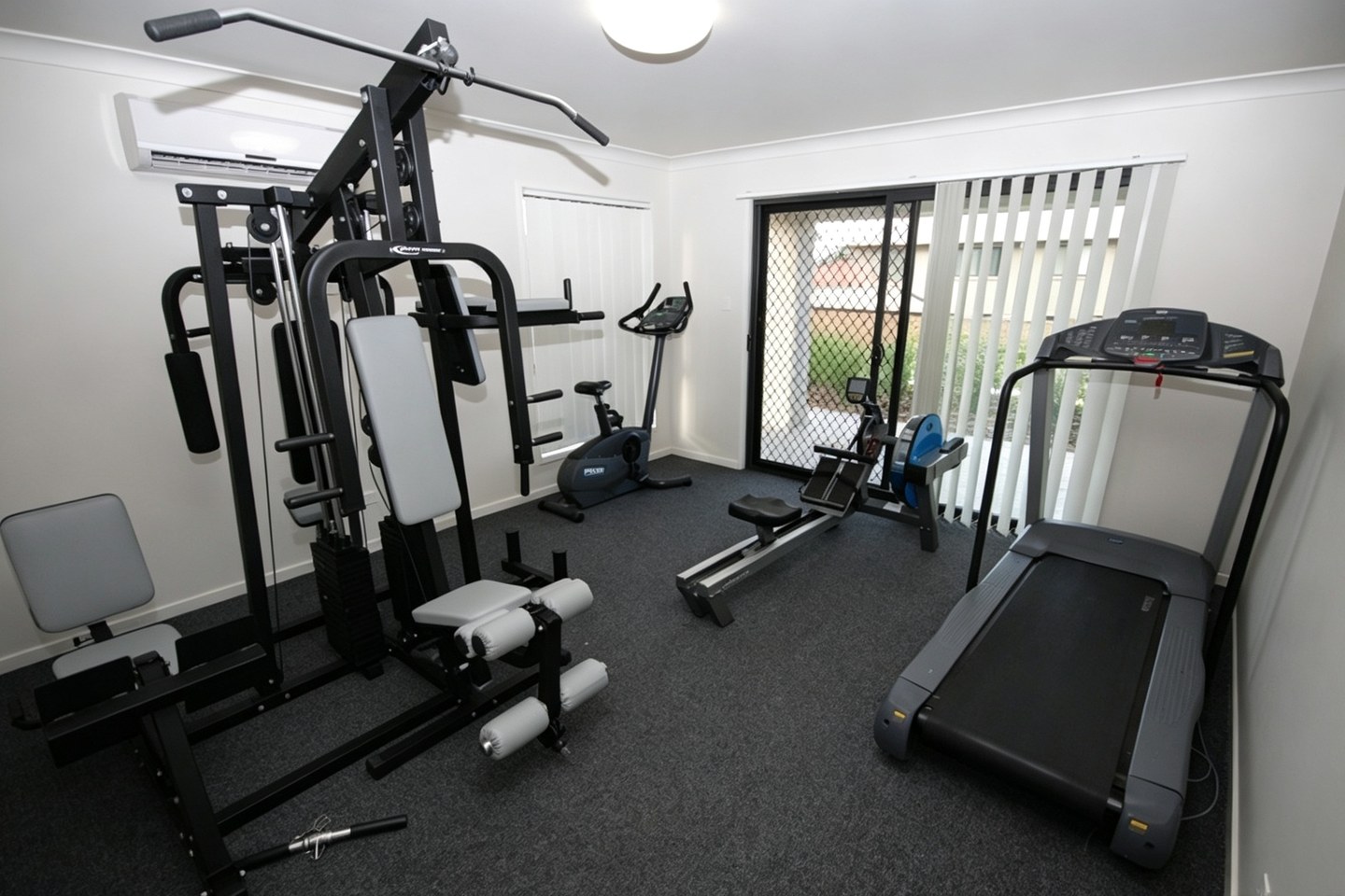 Interior of the Outlook Courts resident gym with strength and cardio equipment